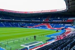 The pitch at Parc des Princes, home stadium of Paris Saint-Germain, on an overcast day. The stadium is mostly empty.