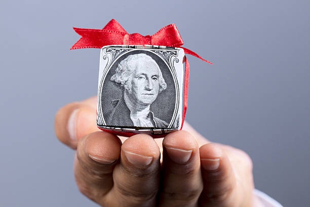 An image with a dollar bill wrapped with a red ribbon denoting the value associated with redeemable and claimable NFTs. 